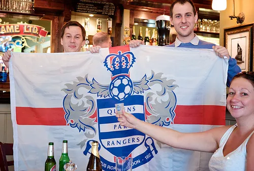 The crew don their QPR flag and shot glass!
