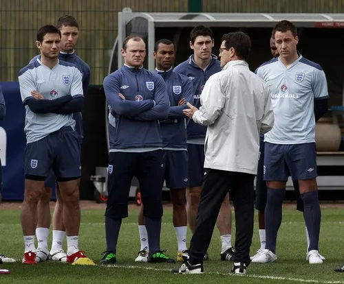England manager Fabio Capello talks to his players during a team training session in London Colney