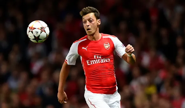 Arsenal's Ozil runs for the ball during their Champions League playoff soccer match against Besiktas at the Emirates stadium in London