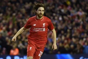 Liverpool's Joe Allen celebrates after scoring the winning penalty in the shoot-out, after their English League Cup semi-final 2nd leg match against Stoke City, at Anfield in Liverpool, on January 26, 2016. Photo credit: AFP.