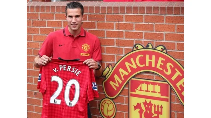 Manchester United's new signing Robin Van Persie poses with his shirt during a photocall at Old Trafford, Manchester.