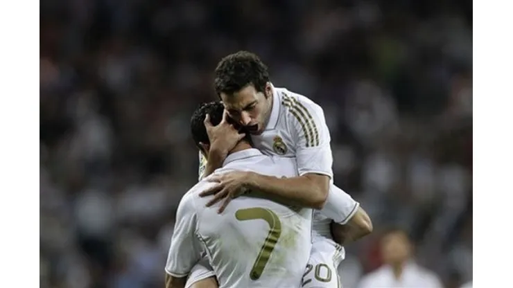 Real Madrid's Gonzalo Higuain from Argentina, top, celebrates after scoring against Getafe with Cristiano Ronaldo from Portugal, bottom, during a Spanish La Liga soccer match at the Santiago Bernabeu stadium in Madrid, Saturday, Sept. 10, 2011. (AP Photo/Arturo Rodriguez)
