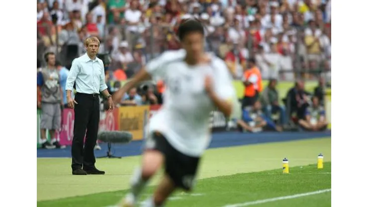 Jurgen Klinsmann, Germany coach looks on as Michael Ballack attacks