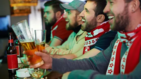 Football fans watching game at bar