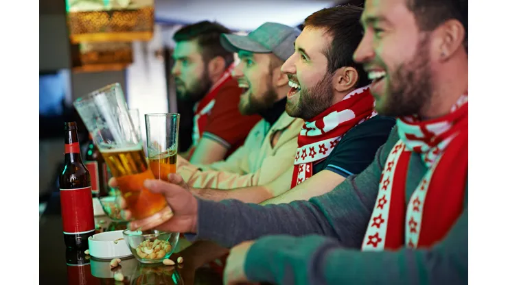 Football fans watching game at bar