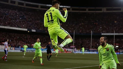 Barcelona's Neymar, centre, celebrates his goal with team mates during a second leg quarterfinal Copa del Rey soccer match between Atletico de Madrid and FC Barcelona at the Vicente Calderon stadium in Madrid, Spain, Wednesday, Jan. 28, 2015. (AP Photo/Andres Kudacki)