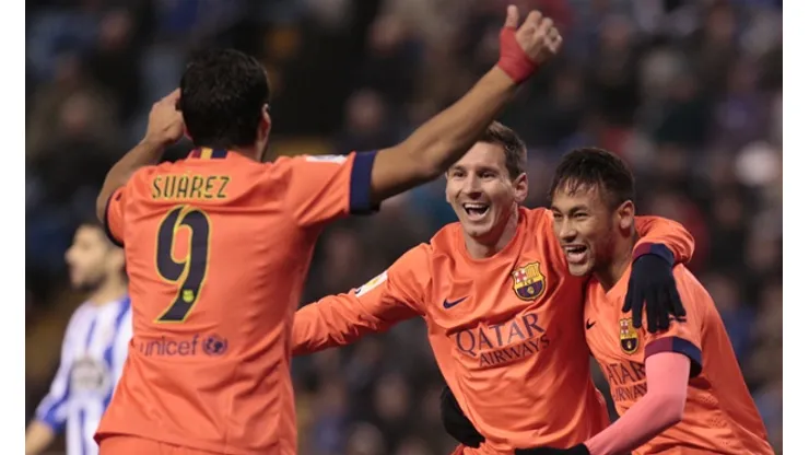 Barcelona's Lionel Messi, center, celebrates after scoring against Deportivo with teammates Neymar, right, and Luis Suarez during a Spanish La Liga soccer match at the Riazor stadium in A Coruna, Spain, Sunday, Jan. 18, 2015. (AP Photo/Lalo R. Villar)