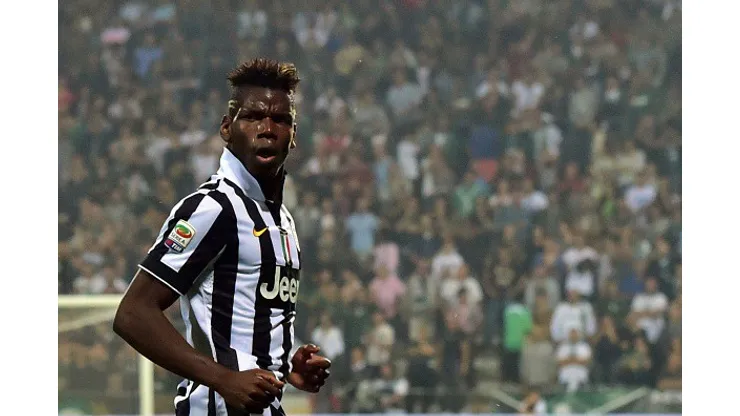 Juventus French midfielder Paul Labile Pogba celebrates after scoring a goal during the Serie A football match between Sassuolo and Juventus at the Mapei Stadium in Reggio Emilia on October 18, 2014 . AFP PHOTO / GIUSEPPE CACACE (Photo credit should read GIUSEPPE CACACE/AFP/Getty Images)
