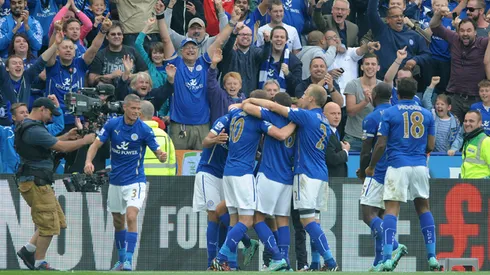 Leicester City players celebrates after Leonardo Ulloa, hidden, scored a penalty to beat Manchetser United 5-3 during the English Premier League soccer match between Leicester City and Manchester United at King Power Stadium, in Leicester, England, Sunday, Sept. 21, 2014. (AP Photo/Rui Vieira)