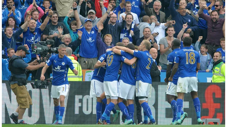 Leicester City players celebrates after Leonardo Ulloa, hidden, scored a penalty to beat Manchetser United 5-3 during the English Premier League soccer match between Leicester City and Manchester United at King Power Stadium, in Leicester, England, Sunday, Sept. 21, 2014. (AP Photo/Rui Vieira)