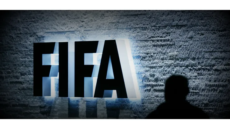 FILE – In this Oct. 29, 2007 file photo, a person stands next to the FIFA logo at the FIFA headquarter in Zurich, Switzerland. The Swiss Federal Office of Justice said six soccer officials have been arrested and detained pending extradition at the request of U.S. authorities ahead of the FIFA congress in Zurich. In a statement Wednesday, May 27, 2015, the FOJ said U.S. authorities suspect the officials of having received paid bribes totaling millions of dollars. (Steffen Schmidt/Keystone via AP, File)
