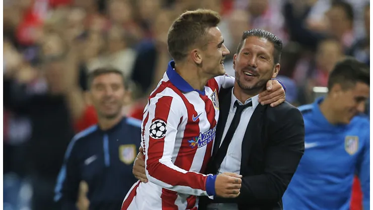 Atletico's Antoine Griezmann, left, celebrates with his coach Diego Simeone after scoring during the Group A Champions League soccer match between Atletico de Madrid and Malmo at the Vicente Calderon stadium in Madrid, Spain, Wednesday, Oct. 22, 2014. (AP Photo/Andres Kudacki)
