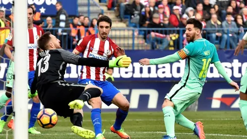 Messi haunts Atletico once more to send Barcelona top