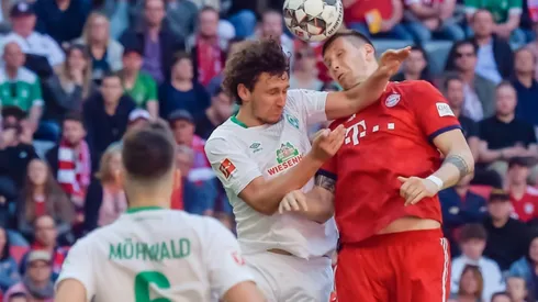 Bayern grind down 10-man Bremen to stay ahead of Dortmund