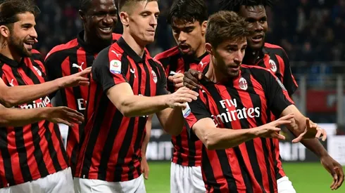 Milan back in Champions League race after fiery Bologna win