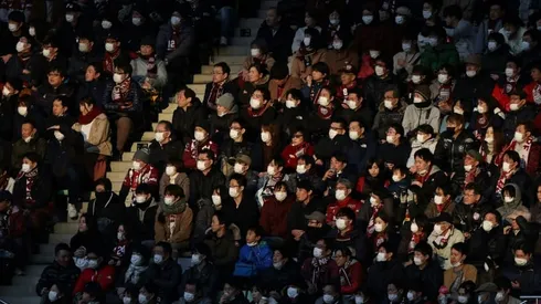 Olympics 'continuing as planned' but virus halts Japanese football