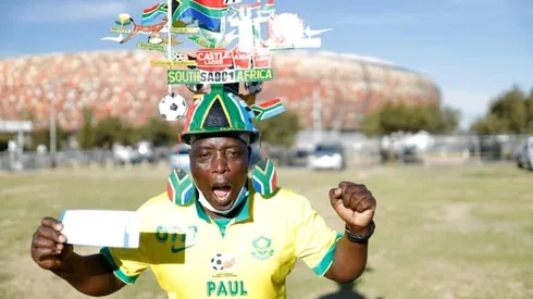 Cheering and hugging, fans return to Soweto stadium