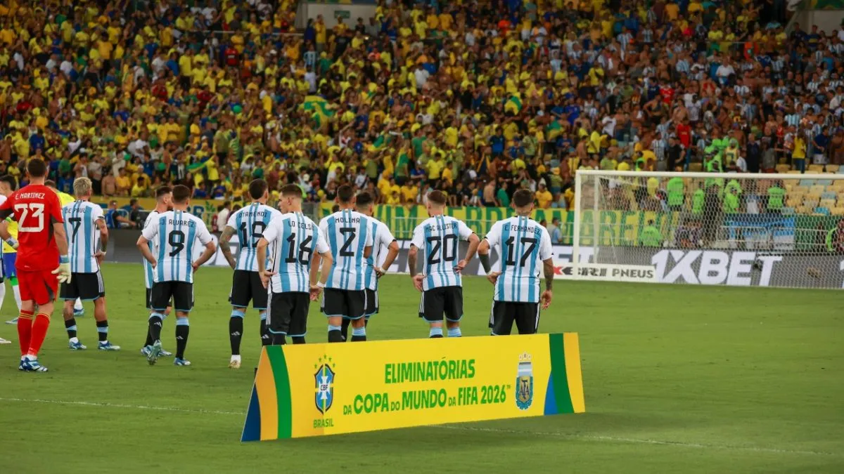 After the national anthems, Argentina players watch on as chaos unfolds in the stands in Rio de Janeiro.