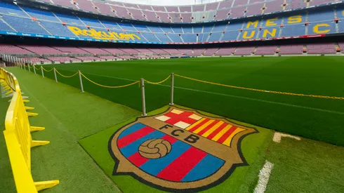 BARCELONA, SPAIN – MAY 23, 2021: Football Club Barcelona emblem on grass of empty Camp Nou stadium field