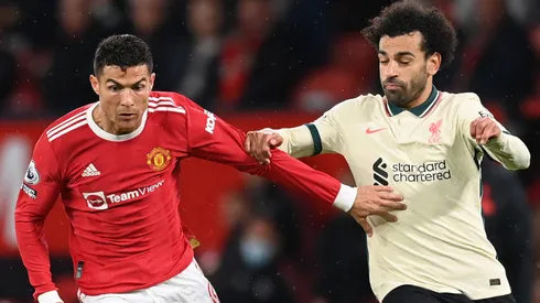 Cristiano Ronaldo of Manchester United holds off Mohamed Salah of Liverpool during the Premier League match between Manchester United and Liverpool at Old Trafford on October 24, 2021 in Manchester, England