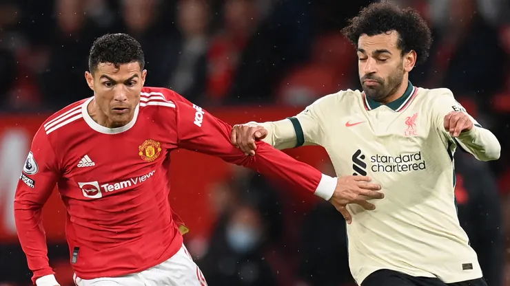 Cristiano Ronaldo of Manchester United holds off Mohamed Salah of Liverpool during the Premier League match between Manchester United and Liverpool at Old Trafford on October 24, 2021 in Manchester, England