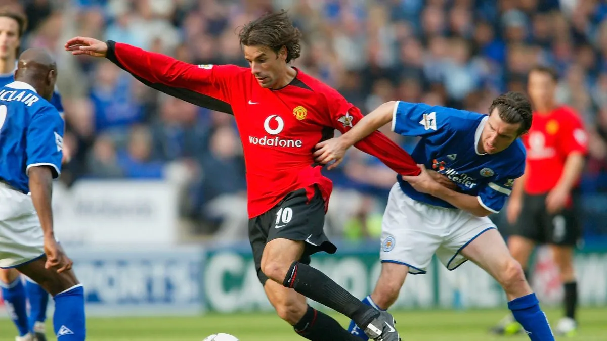 LEICESTER, ENGLAND -SEPTEMBER 27: Ruud Van Nistelrooy of United holds off Muzzy Izzet of Leicester during the FA Barclaycard Premiership match between Leicester City and Manchester United at Walker Stadium on September 27, 2003 in Leicester, England. (Photo by Laurence Griffiths/Getty Images)