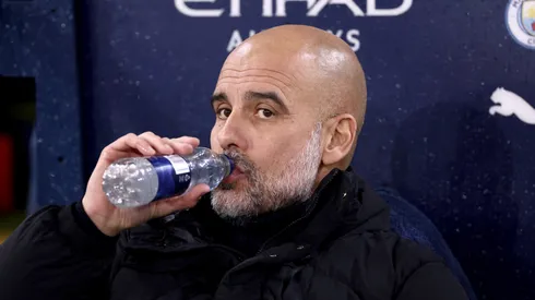 Pep Guardiola, Manager of Manchester City, has a drink prior to the Premier League match between Manchester City FC and Tottenham Hotspur FC at Etihad Stadium on November 23, 2024 in Manchester, England.