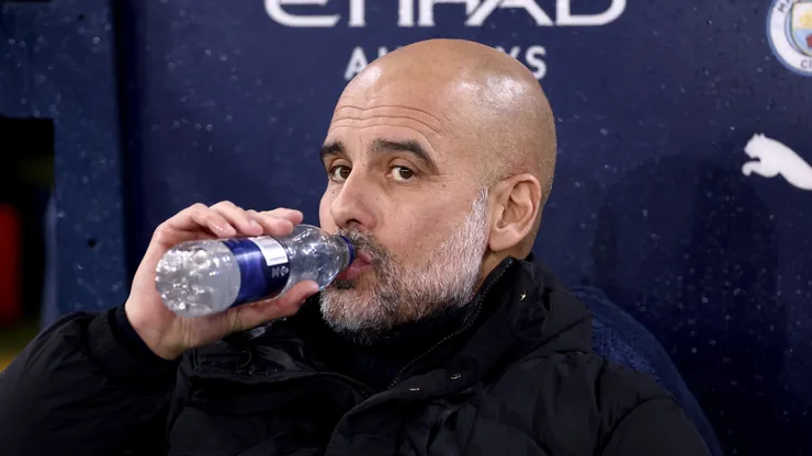 Pep Guardiola, Manager of Manchester City, has a drink prior to the Premier League match between Manchester City FC and Tottenham Hotspur FC at Etihad Stadium on November 23, 2024 in Manchester, England.