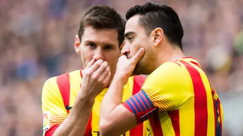 Lionel Messi and Xavi Hernandez (R) of FC Barcelona speak during the La Liga match between RCD Espanyol and FC Barcelona at Cornella-El Prat Stadium on March 29, 2014 in Barcelona, Spain.
