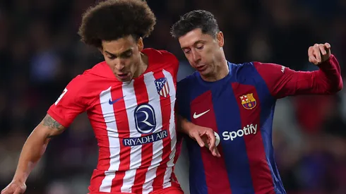 Robert Lewandowski of FC Barcelona challenges for the ball with Axel Witsel of Atletico Madrid during the LaLiga EA Sports match between FC Barcelona and Atletico Madrid at Estadi Olimpic Lluis Companys on December 03, 2023 in Barcelona, Spain.