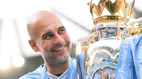 Pep Guardiola, Manager of Manchester City, poses for a photo with the Premier League title trophy following the team's victory in the Premier League match between Manchester City and West Ham United at Etihad Stadium on May 19, 2024 in Manchester, England.