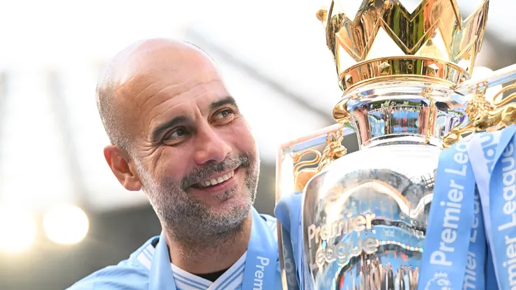 Pep Guardiola, Manager of Manchester City, poses for a photo with the Premier League title trophy following the team's victory in the Premier League match between Manchester City and West Ham United at Etihad Stadium on May 19, 2024 in Manchester, England.
