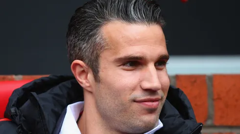 Robin van Persie of Manchester United looks on from the bench prior to the Barclays Premier League match between Manchester United and Arsenal at Old Trafford on May 17, 2015 in Manchester, England.