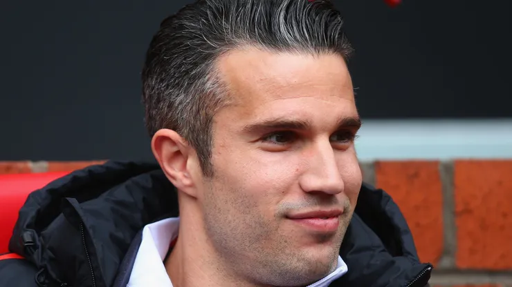 Robin van Persie of Manchester United looks on from the bench prior to the Barclays Premier League match between Manchester United and Arsenal at Old Trafford on May 17, 2015 in Manchester, England.