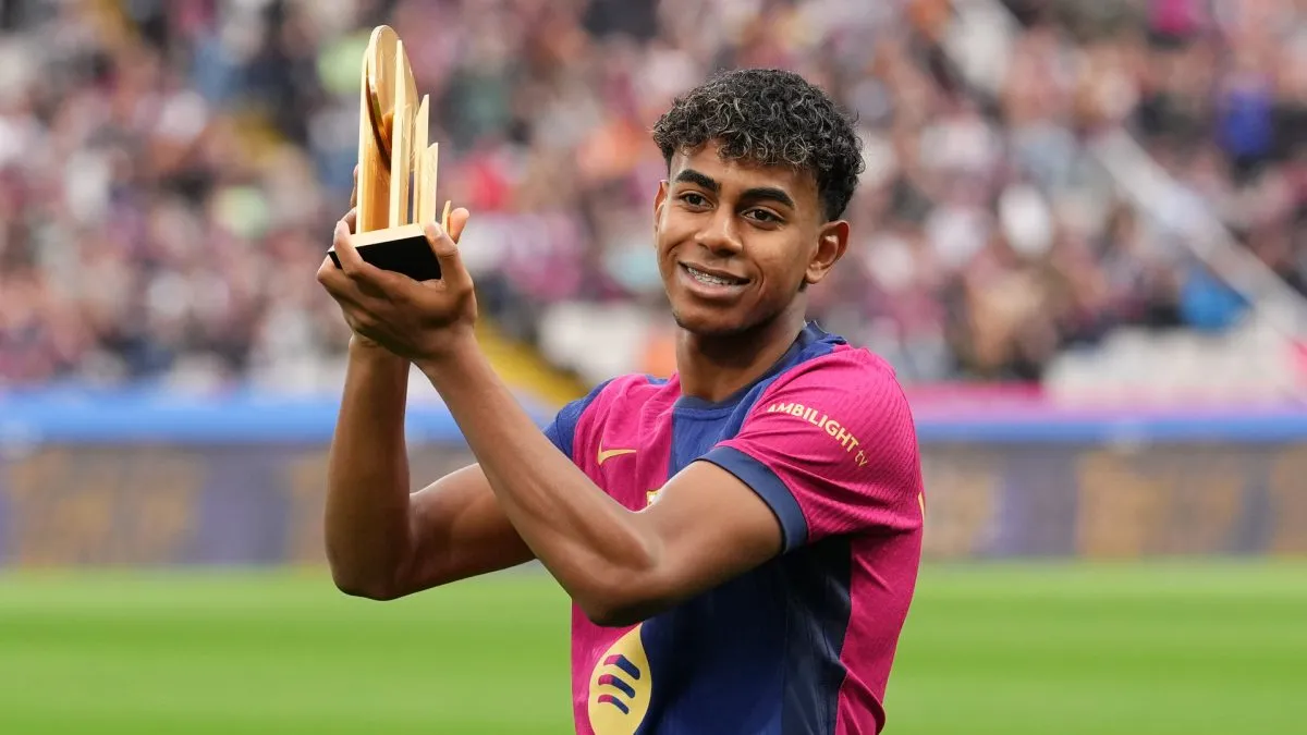 Lamine Yamal of FC Barcelona acknowledges the fans as he displays his 2024 Kopa Trophy