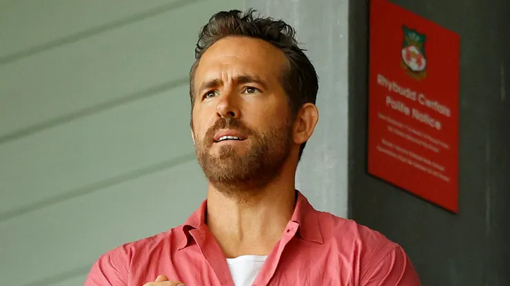 Co-owner of Wrexham Football Club Ryan Reynolds removes his jacket during the Sky Bet League Two match between Wrexham and Milton Keynes Dons at Stok Cae Ras stadium on August 05, 2023 in Wrexham, Wales.