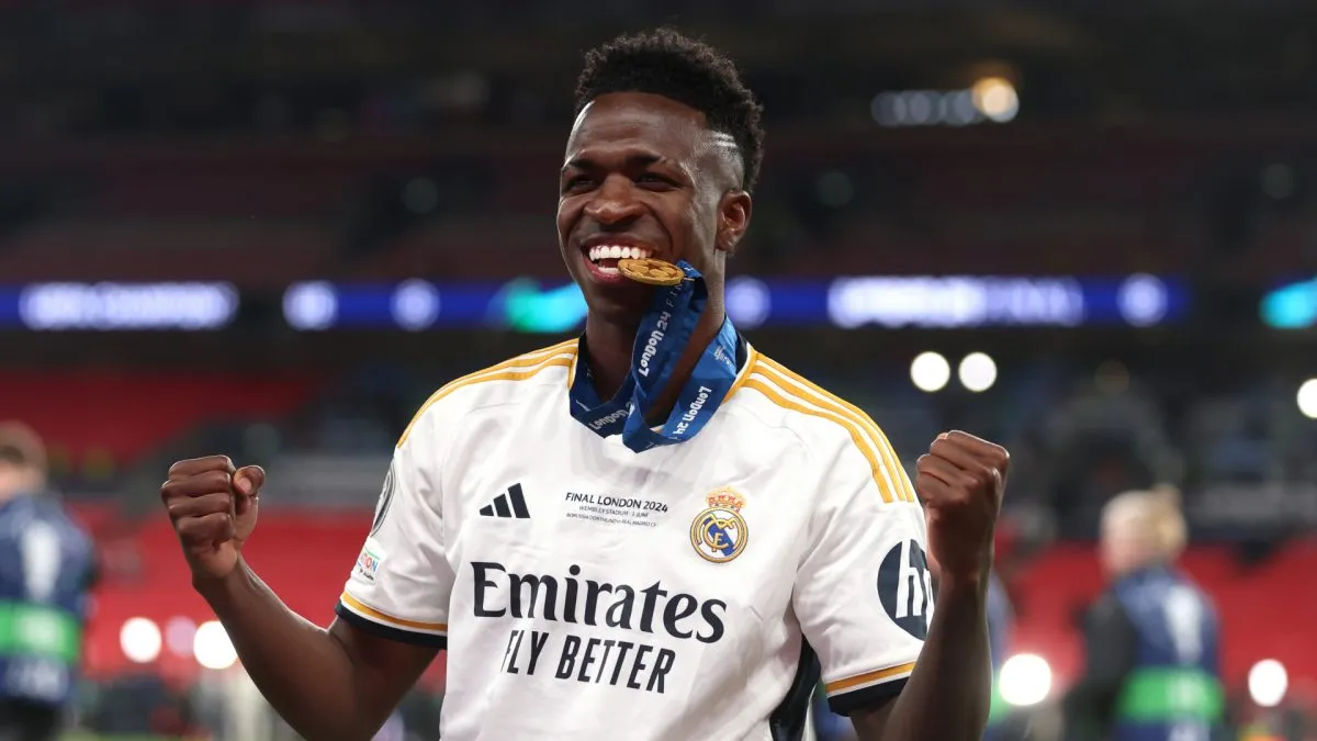 Vinicius Junior of Real Madrid bites his winners medal