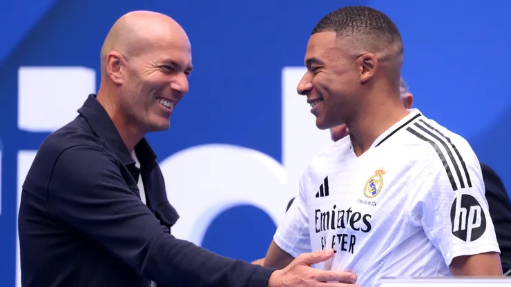 Real Madrid new signing, Kylian Mbappe (R) is greeted by former Real Madrid player and coach, Zinedine Zidane as he is unveiled at Estadio Santiago Bernabeu on July 16, 2024 in Madrid, Spain.