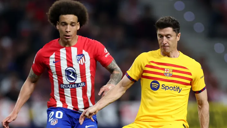 Robert Lewandowski of FC Barcelona is challenged by Axel Witsel of Atletico Madrid during the LaLiga EA Sports match between Atletico Madrid and FC Barcelona at Civitas Metropolitano Stadium on March 17, 2024 in Madrid, Spain.