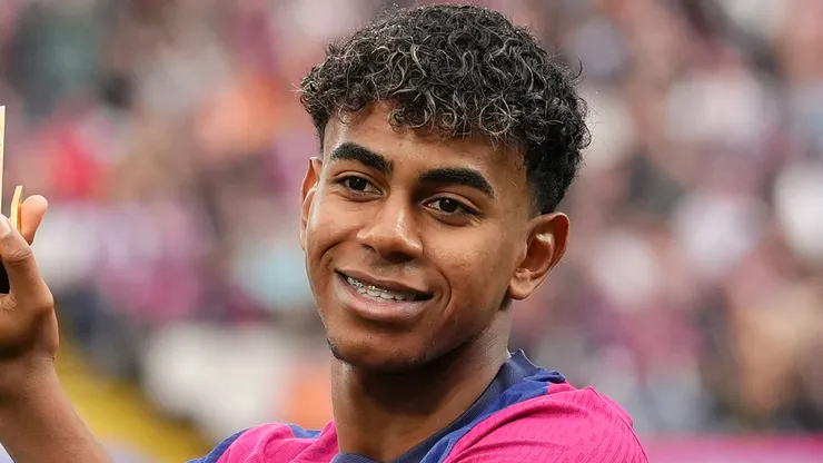 Lamine Yamal of FC Barcelona acknowledges the fans as he displays his 2024 Kopa Trophy prior to the La Liga EA Sports match between FC Barcelona and RCD Espanyol at Estadi Olimpic Lluis Companys on November 03, 2024 in Barcelona, Spain.