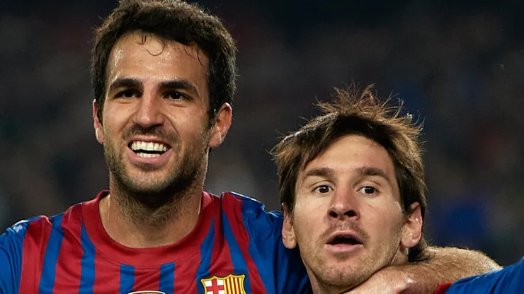 Lionel Messi (R) of Barcelona celebrates with team-mate Cesc Fabregas after scoring the opening goal during the UEFA Champions League quarter-final second leg match between FC Barcelona and AC Milan at the Camp Nou stadium on April 3, 2012 in Barcelona, Spain.