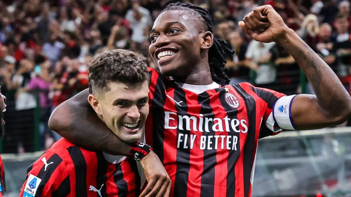Christian Pulisic and Rafael Leao celebrating.