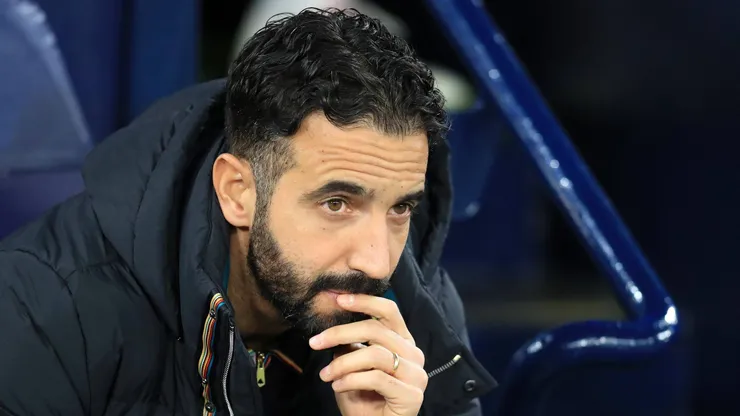 Manchester United manager Ruben Amorim watches play from his seat in the dugout.