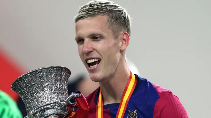 Dani Olmo of FC Barcelona celebrates with the Supercopa de Espana winners' trophy during the trophy presentation after the Spanish Super Cup Final between Real Madrid and FC Barcelona at King Abdullah Sports City on January 12, 2025 in Jeddah, Saudi Arabia.