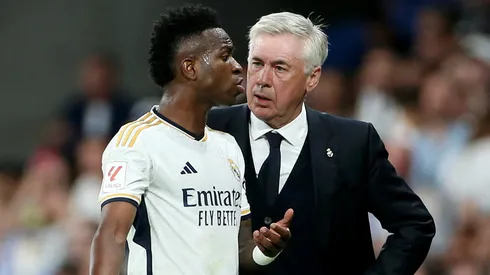 Vinicius Junior of Real Madrid interacts with Carlo Ancelotti, Head Coach of Real Madrid, after being substituted during the LaLiga EA Sports match between Real Madrid CF and FC Barcelona at Estadio Santiago Bernabeu on April 21, 2024 in Madrid, Spain.