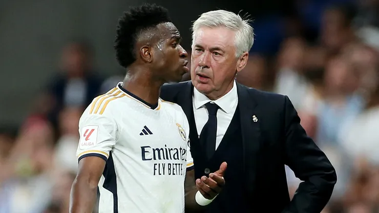 Vinicius Junior of Real Madrid interacts with Carlo Ancelotti, Head Coach of Real Madrid, after being substituted during the LaLiga EA Sports match between Real Madrid CF and FC Barcelona at Estadio Santiago Bernabeu on April 21, 2024 in Madrid, Spain.