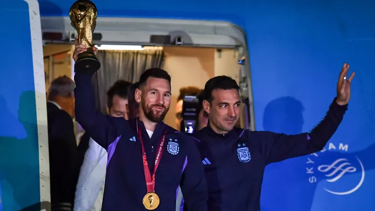 Lionel Messi of Argentina (L) and Lionel Scaloni (R) holds the FIFA World Cup during the arrival of the Argentina men's national football team after winning the FIFA World Cup Qatar 2022 on December 20, 2022 in Buenos Aires, Argentina.