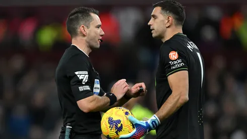 Referee, Jarred Gillett speaks to Emiliano Martinez of Aston Villa during the Premier League match between Aston Villa and Arsenal FC at Villa Park on December 09, 2023 in Birmingham, England.