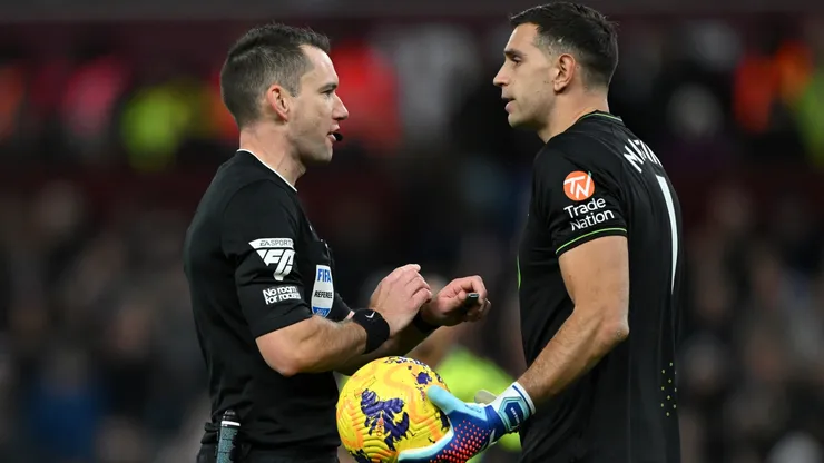Referee, Jarred Gillett speaks to Emiliano Martinez of Aston Villa during the Premier League match between Aston Villa and Arsenal FC at Villa Park on December 09, 2023 in Birmingham, England.