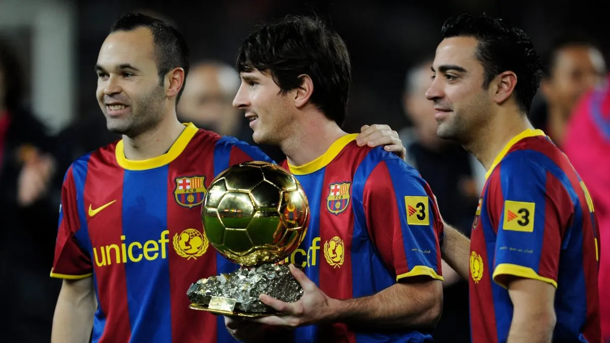 Lionel Messi of FC Barcelona (C) holds the Ballon d'Or trophy flanked by his teammates Andres Iniesta (L) and Xavi Hermandez prior the Copa del Rey quarter final first leg match FC Barcelona and Betis at Camp Nou on January 12, 2011 in Barcelona, Spain.